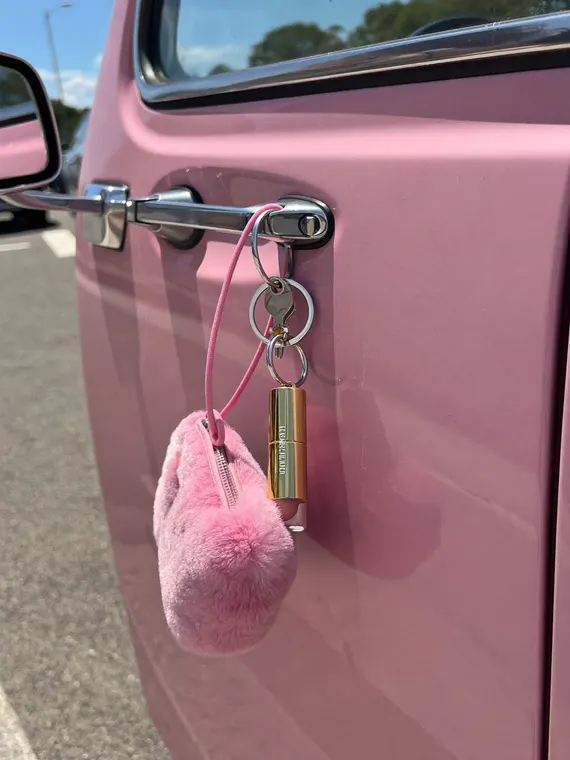 Bag and accessories product photography: bag charms, pink car door lock
