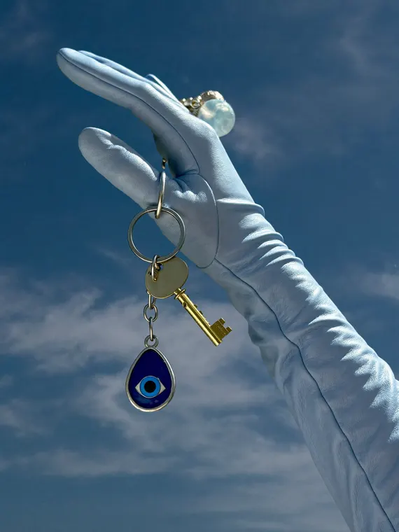 Bag and accessories product photography: keyring, blue glove and evil eye