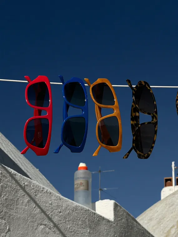 Bag and accessories product photography: sunglasses, washing line over the rooftops