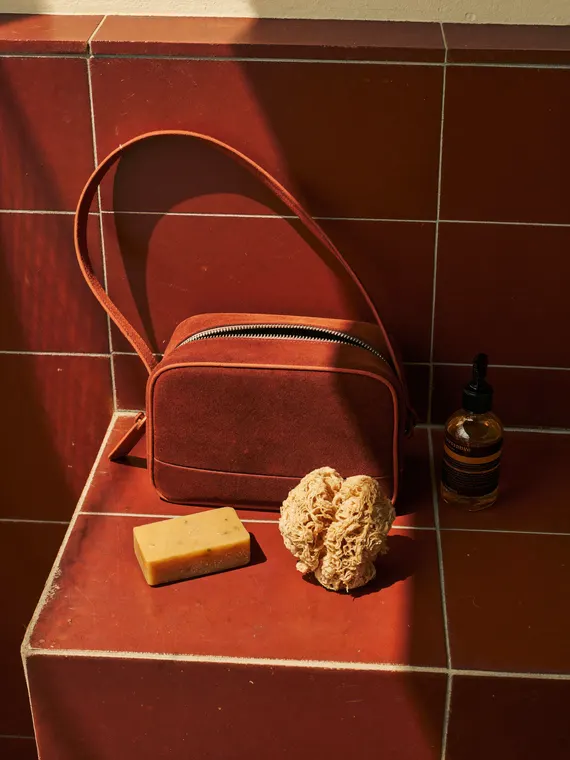 Bag and accessories product photography: toiletry bag, red tiles