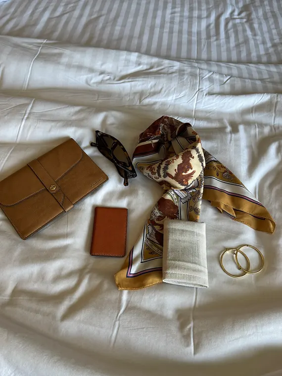 Bag and accessories product photography: travel flat lay, hotel bed