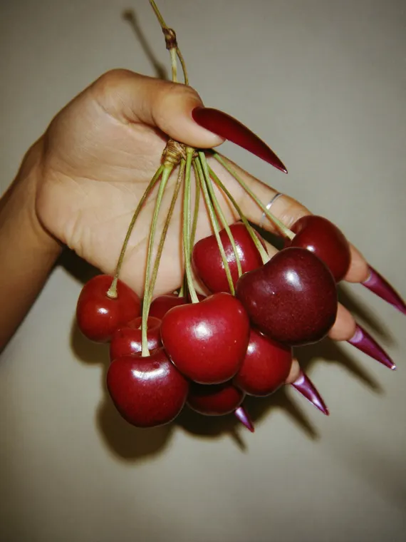 Beauty model shoot: nails, cherry red manicure and cherries