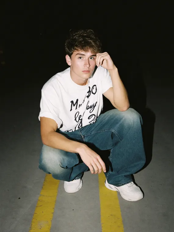AI fashion model shoot: streetwear, crouched on the parking lines