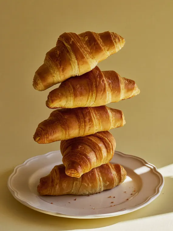 Food and beverage product photography: bakery, croissant tower on cream