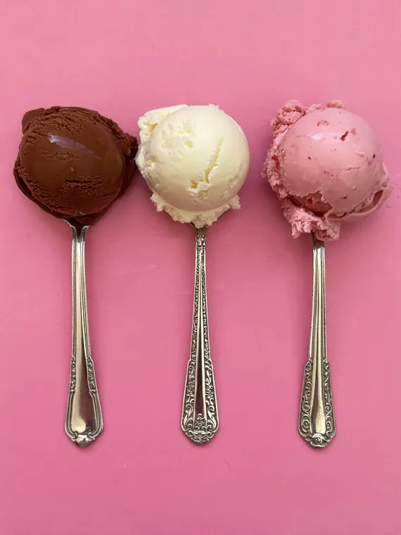 Food and beverage product photography: ice cream, three scoops on silver spoons