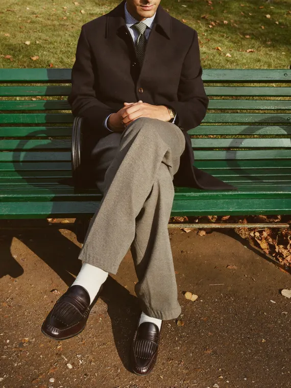 Footwear model shoot: loafers, autumn park bench