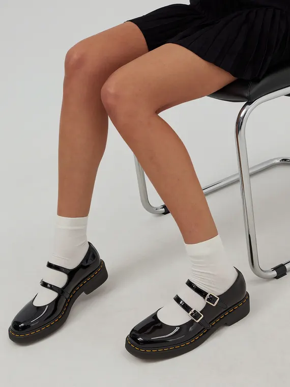 Footwear model shoot: mary janes, white socks on the chrome chair