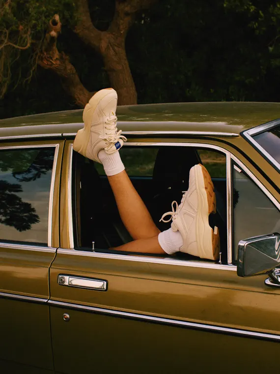 Footwear model shoot: sneakers, legs out of the car window