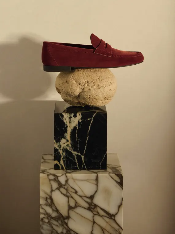 Shoe product photography: loafer balanced on the stones