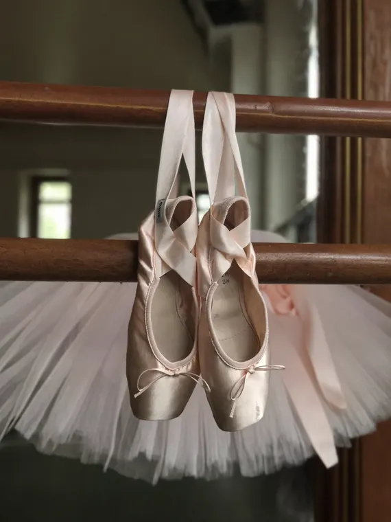 Shoe product photography: pointe shoes hanging from the barre
