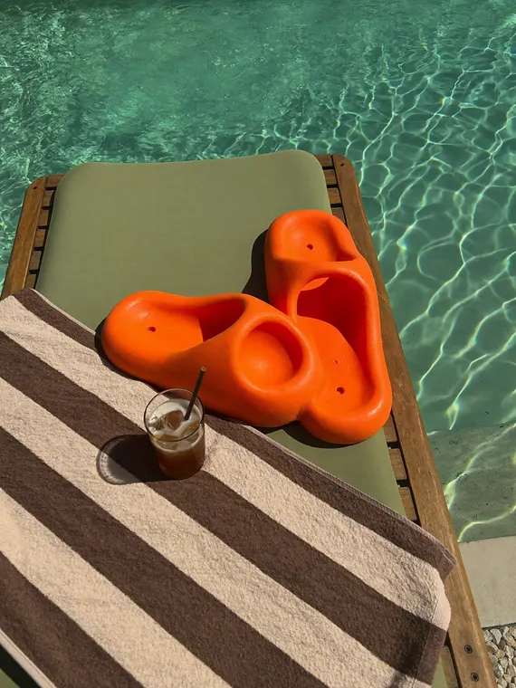 Shoe product photography: slides on the sun lounger