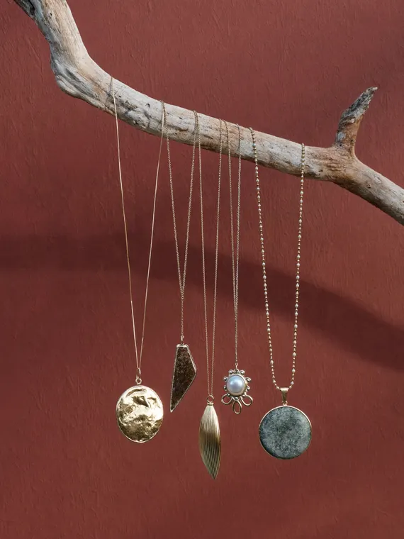 Jewellery product photography: necklaces hanging from driftwood